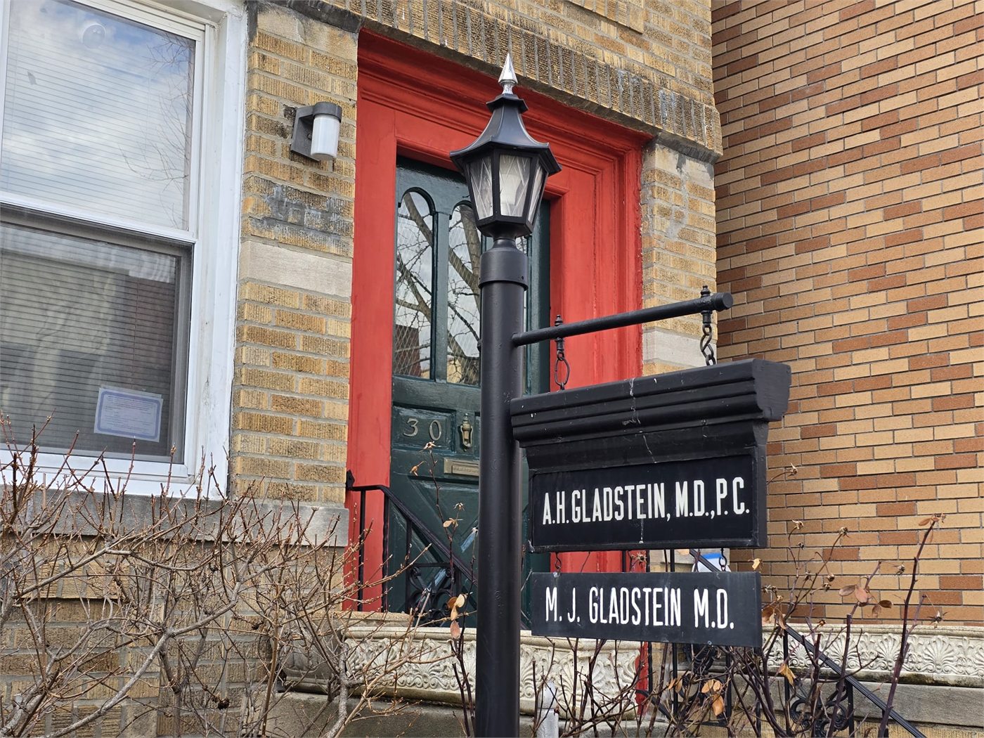 Clinic sign for Dr. Michael Gladstein, MD in Astoria